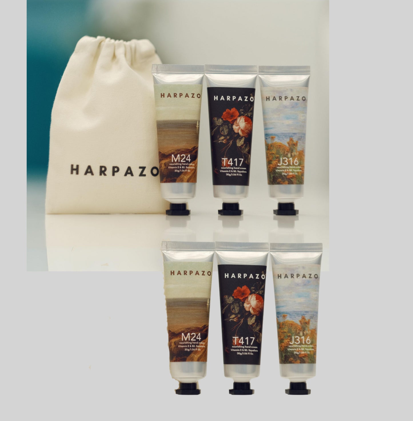 A set of six travel size hand creams with floral designs on each tube, displayed alongside a mini ribbon gift bag with the brand name 'HARPZAO'.