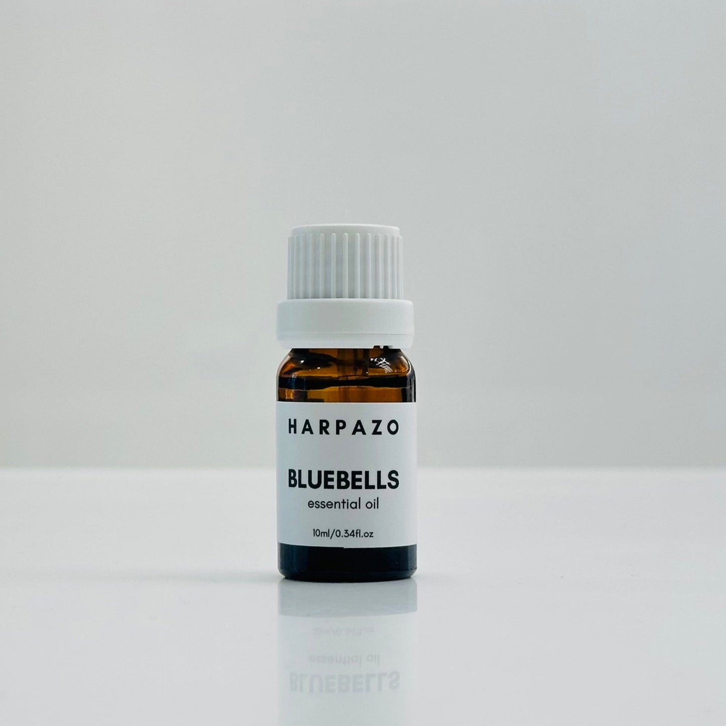 A small bottle labeled 'BLUEBELLS essential oil 10ml' with a white cap, displayed against a white background.