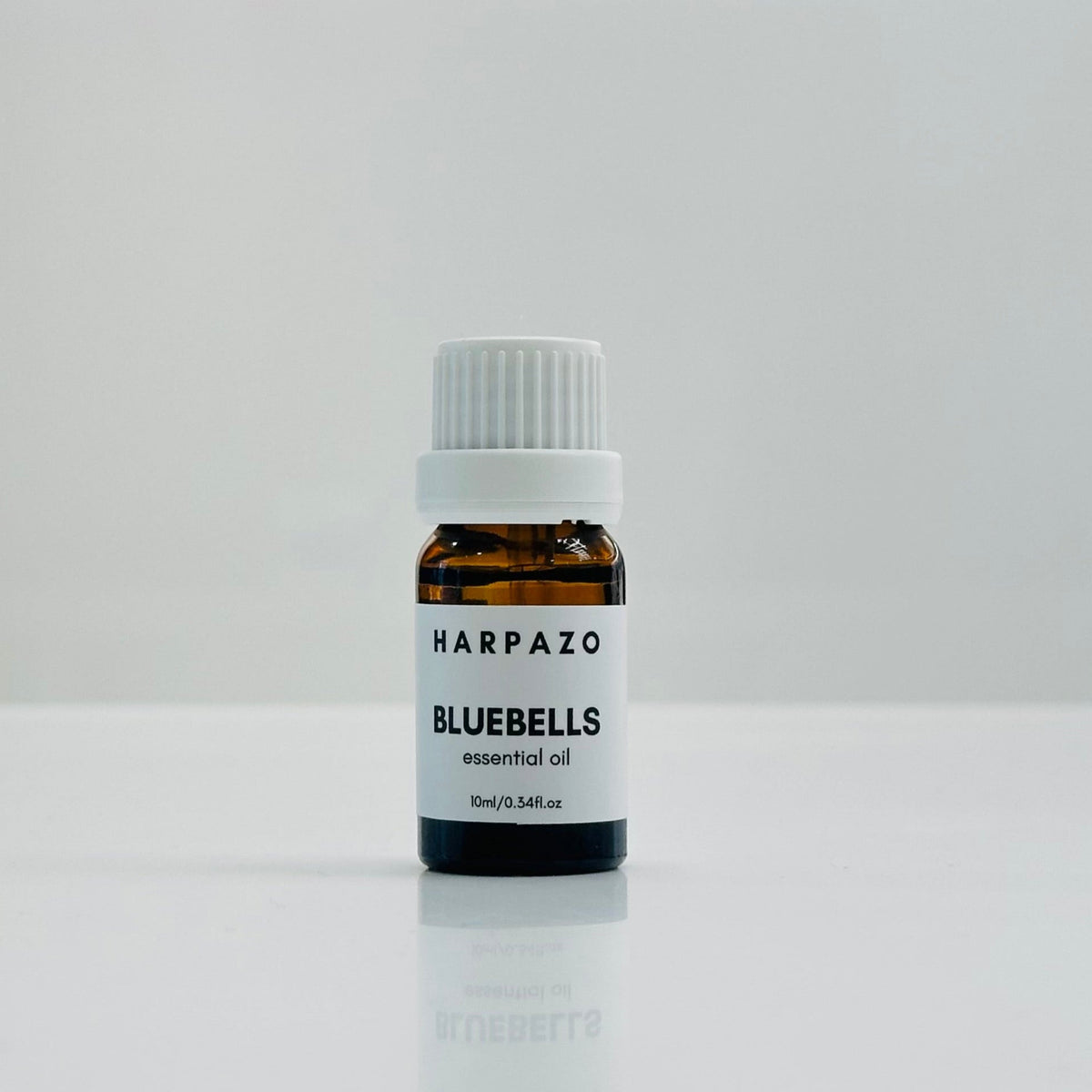 A small bottle labeled 'BLUEBELLS essential oil 10ml' with a white cap, displayed against a white background.