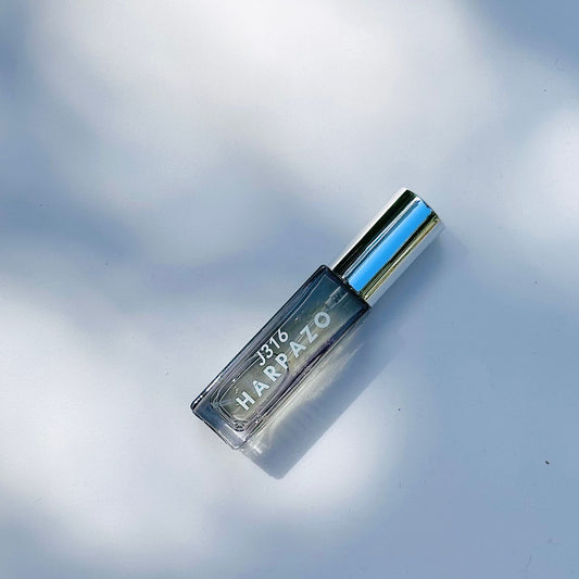 Small bottle labeled 'H316 Harpazo' on a reflective surface