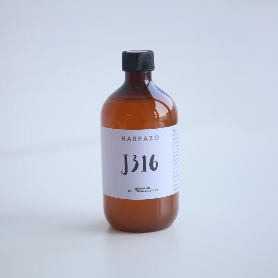 A brown bottle of Harpazo J316 Moisturizing Shower Gel with a white label on a white background.