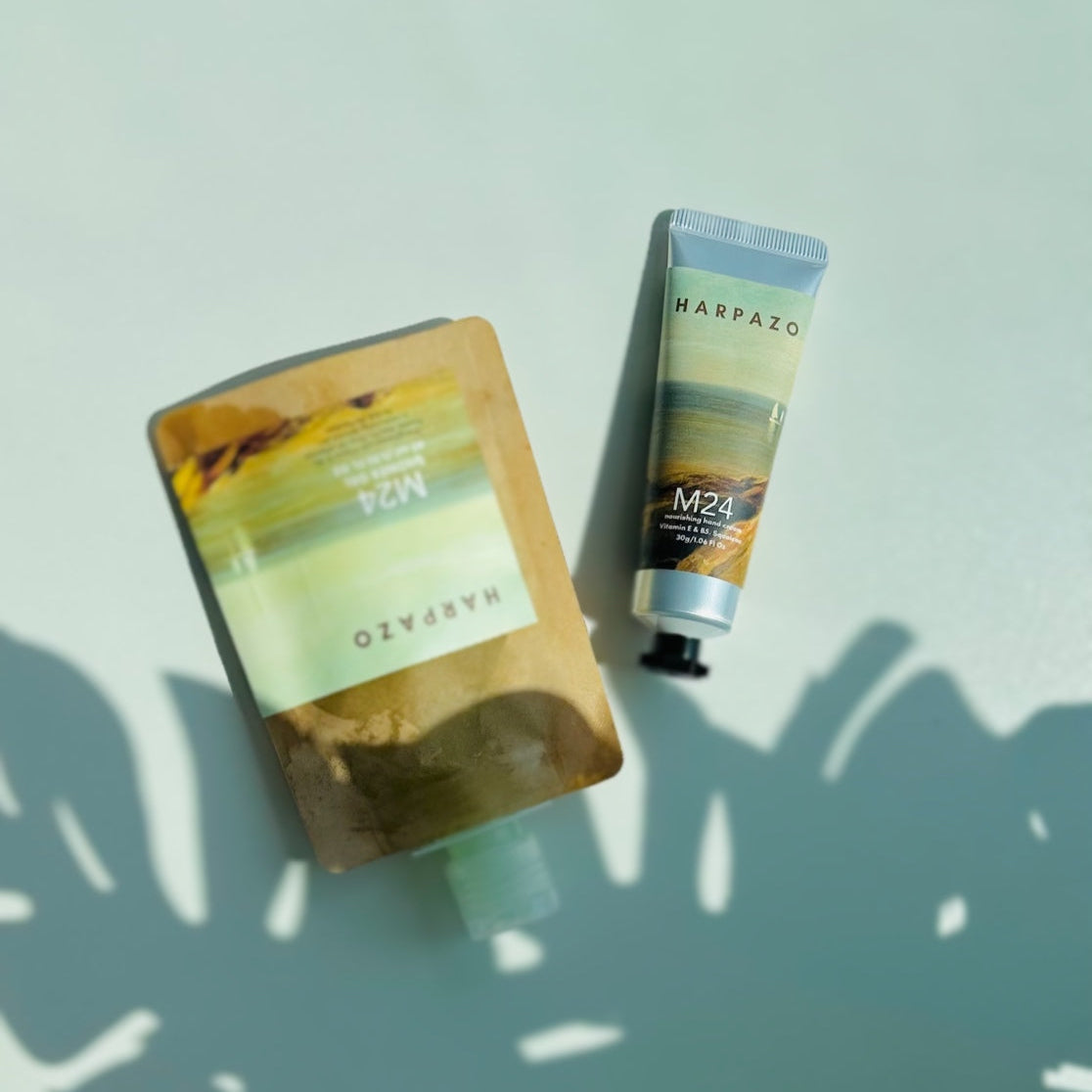 A travel care set consisting of a moisturizing hand cream tube and a travel shower gel bottle, displayed on a light background.