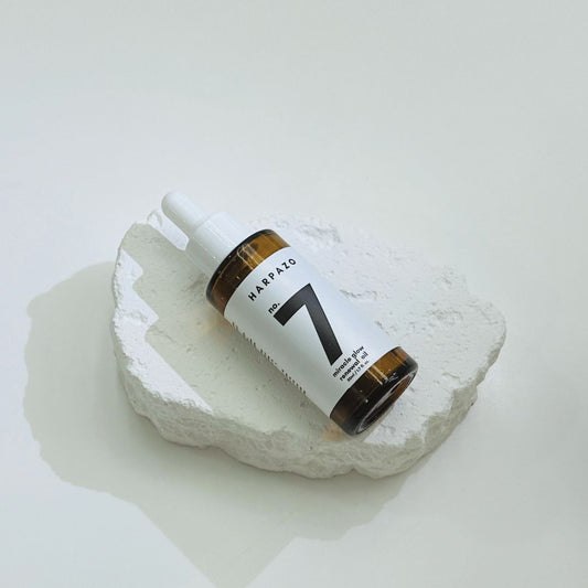 Bottle labeled 'Harpazo No. 7' on a white stone surface
