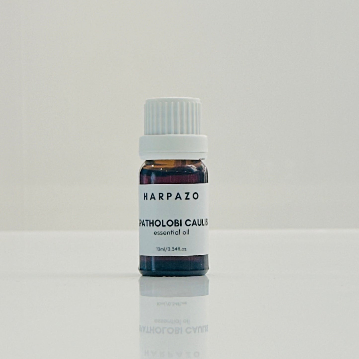 A small bottle labeled 'SPATHOLOBUS CAULIS essential oil 10ml' with a white cap, presented on a white background.