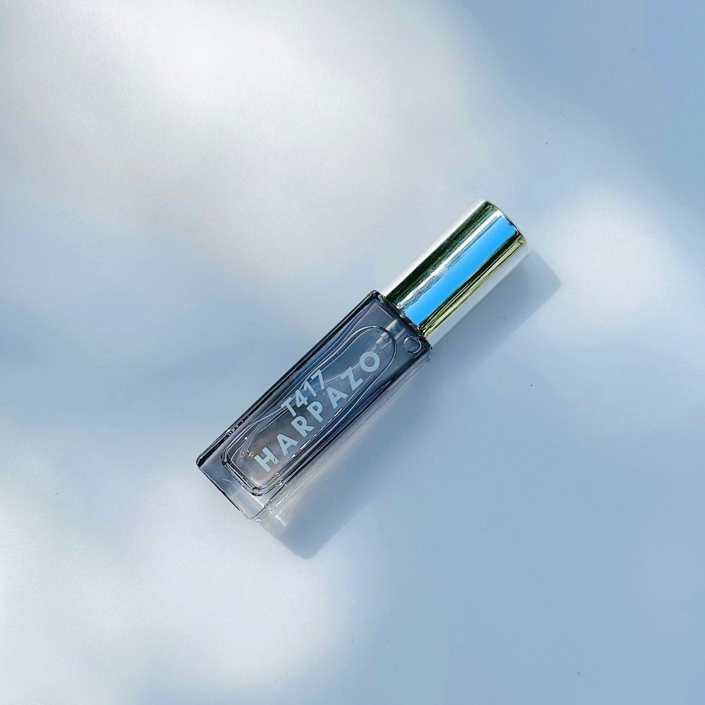 Travel bottle with 'Harpazo' branding on a light blue background