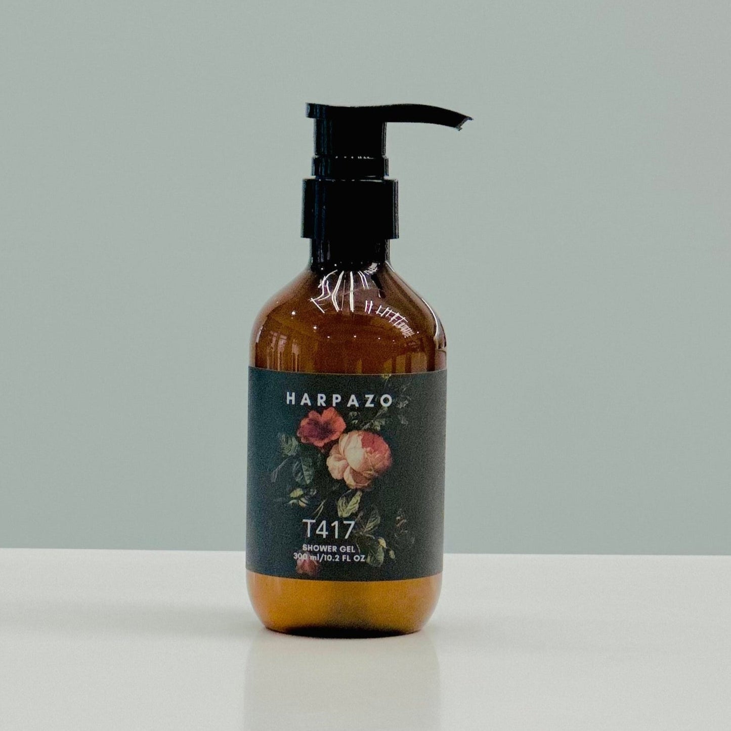 A pump bottle of T417 Moisturizing Shower Gel with a floral design on the label, placed against a neutral background.