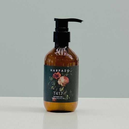A pump bottle of T417 Moisturizing Shower Gel with a floral design on the label, placed against a neutral background.
