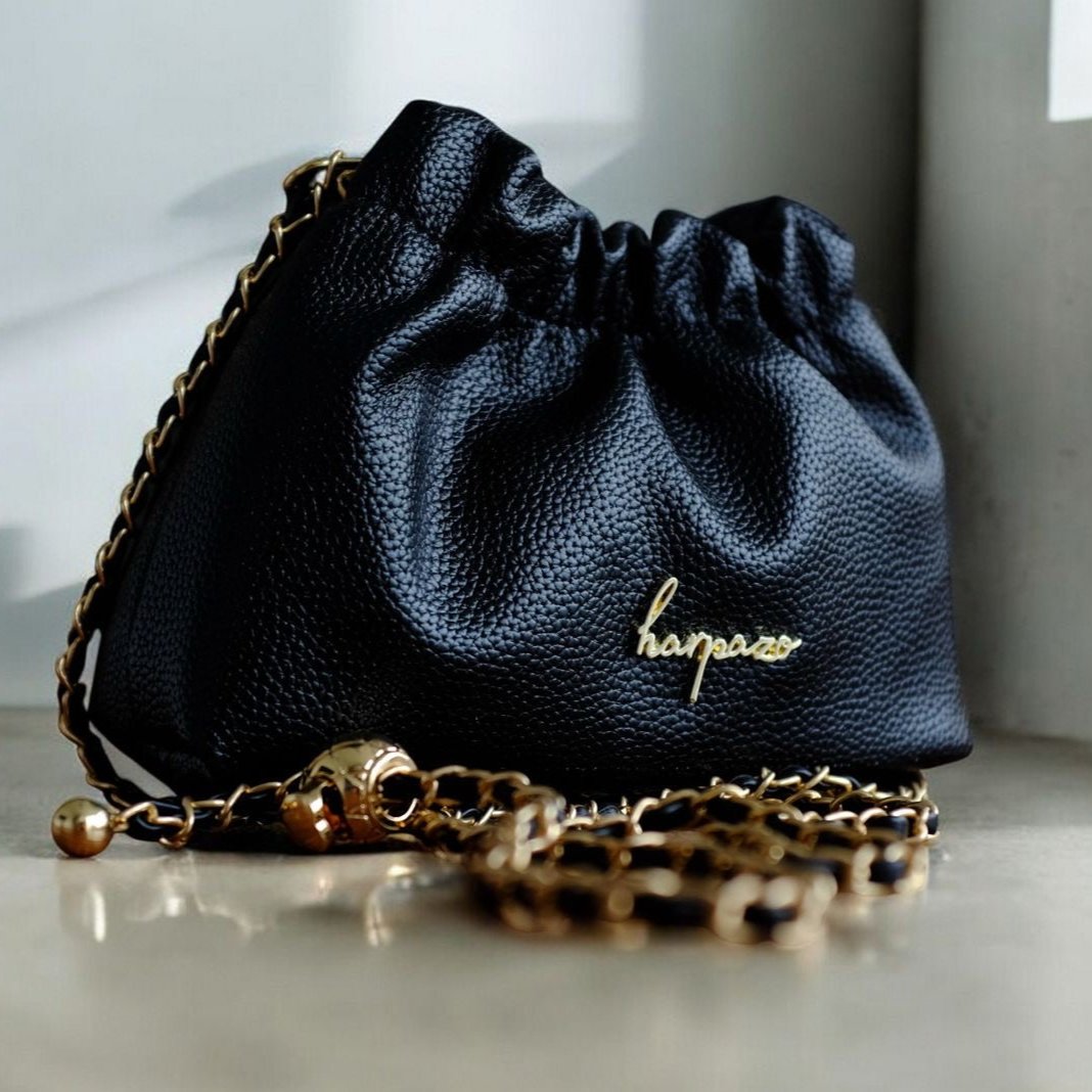 A black faux leather mini bag with a chain strap and the brand name 'Harpazo' visible on the front.