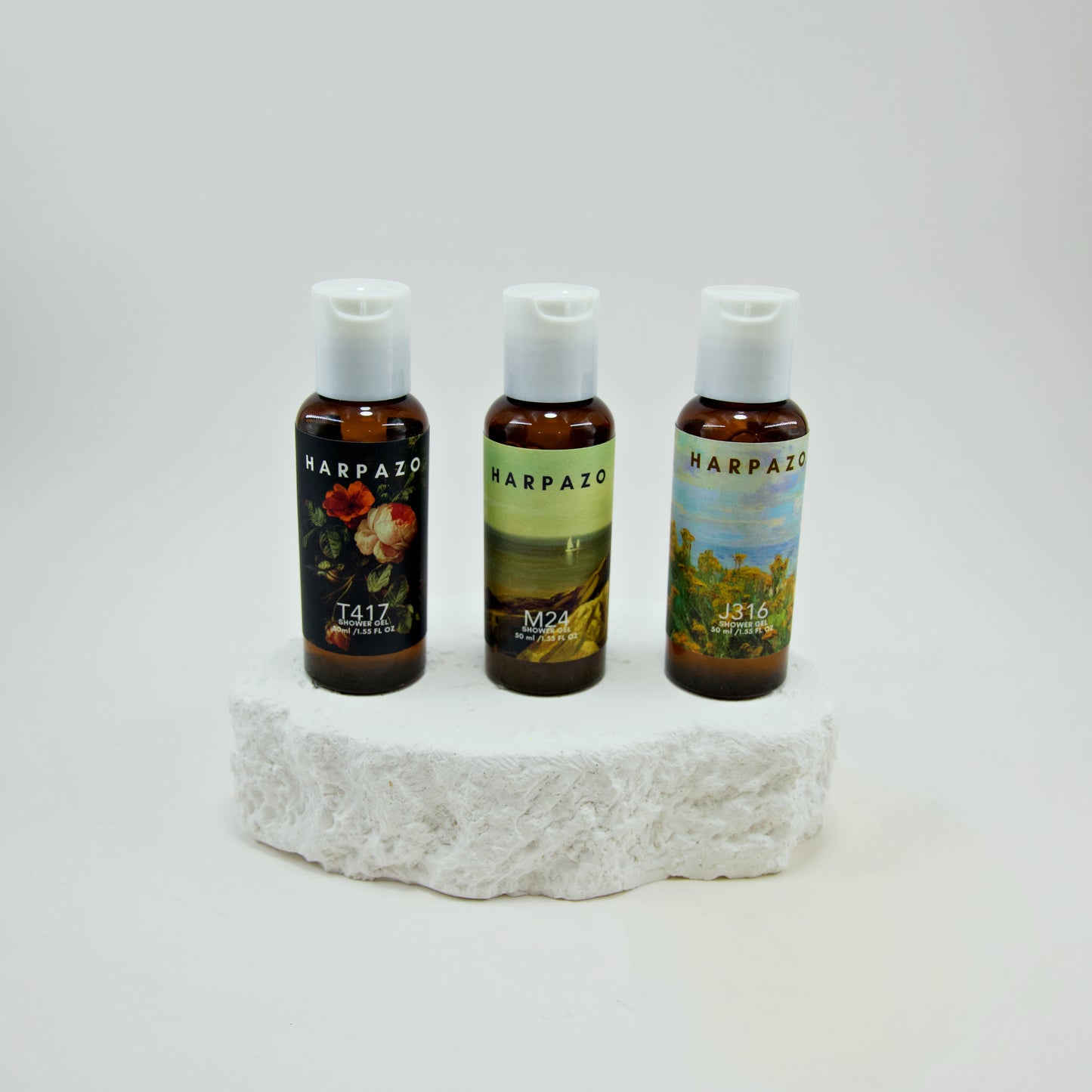 Three bottles of Harpazo on a stone surface with a white background