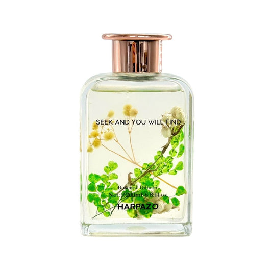 A glass reed diffuser bottle with a floral design and the brand name 'Harpazo' on the label.