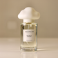 Perfume bottle with a cloud-shaped cap on a beige background