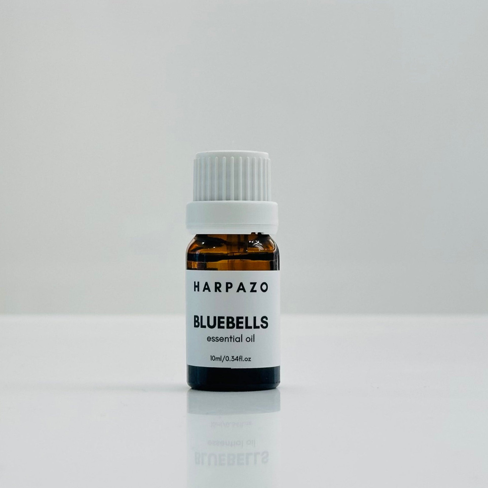 A small bottle labeled 'BLUEBELLS essential oil 10ml' with a white cap, displayed against a white background.