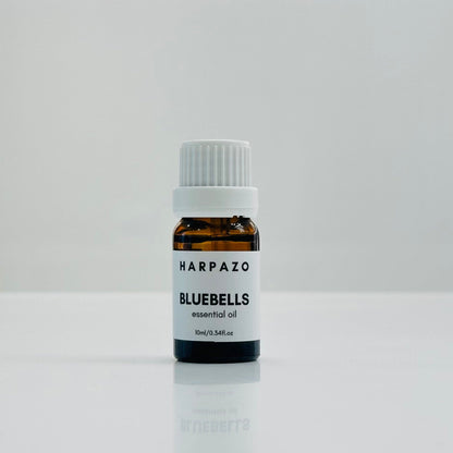 A small bottle labeled 'BLUEBELLS essential oil 10ml' with a white cap, displayed against a white background.