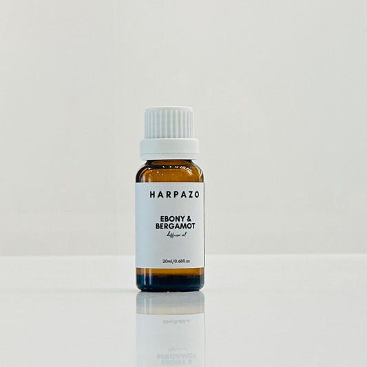 A small bottle labeled 'HARPAZO Ebony & Bergamot' on a light background.