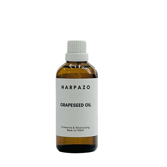 A bottle of HARPAZO Grapeseed Carrier Oil with a capacity of 100ml, featuring a white label and cap.