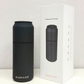 Black air purifier with 'Harpazo' branding next to its packaging on a white background