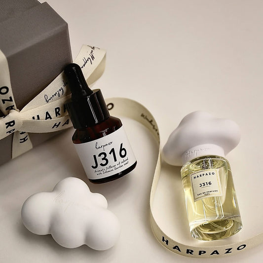 Two Harpazo perfume bottles, one dropper bottle and one spray bottle, on a light background.