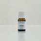 A small bottle labeled LOTUS essential oil on a light background.