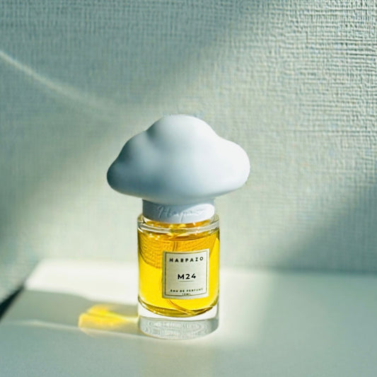 A perfume bottle with a cloud-shaped cap, labeled M24 15ml EDP, on a light background.
