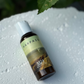 Harpazo M24 shower gel bottle on a textured white surface with a leaf in the background