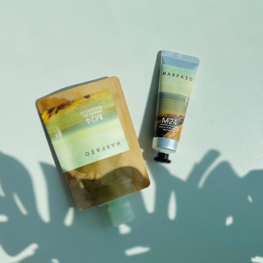 A travel care set consisting of a moisturizing hand cream tube and a travel shower gel bottle, displayed on a light background.