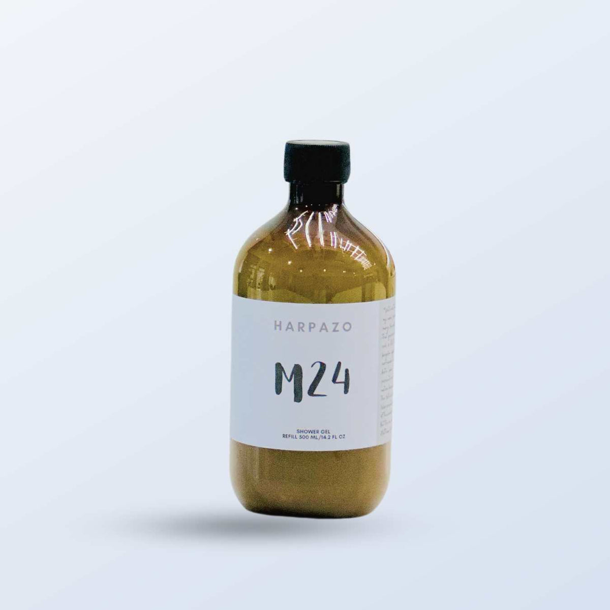 A clear bottle of Harpazo M24 moisturizing shower gel with a label showing the product name and volume.