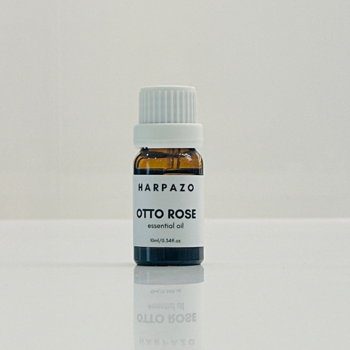 A small bottle labeled 'HARPAZO OTTO ROSE essential oil 10ml' set against a white background.