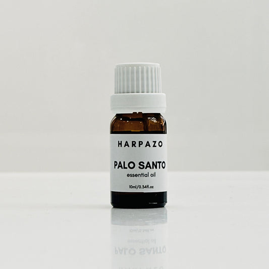 A small bottle labeled 'HARPAZO PALO SANTO essential oil 10ml' set against a white background.