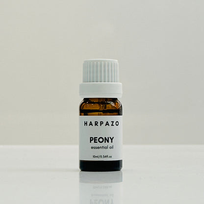 A small glass bottle labeled 'HARPAZO PEONY essential oil' with a white cap, containing 10ml of oil.