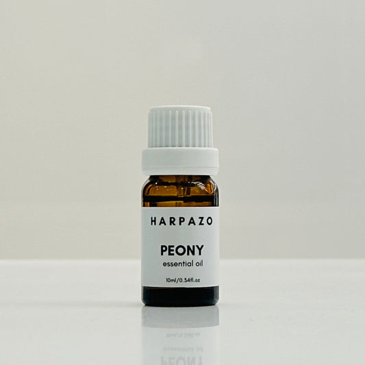 A small glass bottle labeled 'HARPAZO PEONY essential oil' with a white cap, containing 10ml of oil.