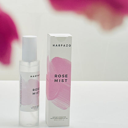 Harpazo Rose Mist bottle and packaging with pink floral background