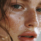 Close-up of a person's face with water droplets on skin
