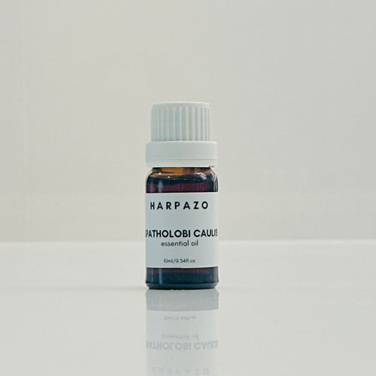 A small bottle labeled 'SPATHOLOBUS CAULIS essential oil 10ml' with a white cap, presented on a white background.